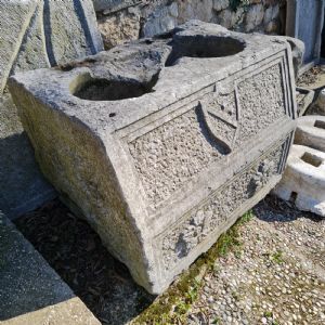 Antique fountain with coat of arms and rosettes